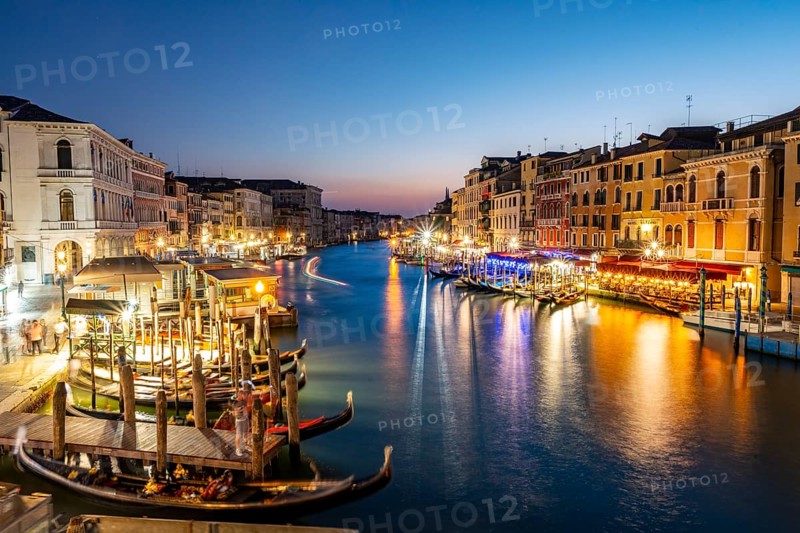 View of the Grand Canal at the blue hour, picturesque evening mood with illuminated palazzos on the canal, long exposure, view from the Rialto Bridge, Venice, Veneto, Italy