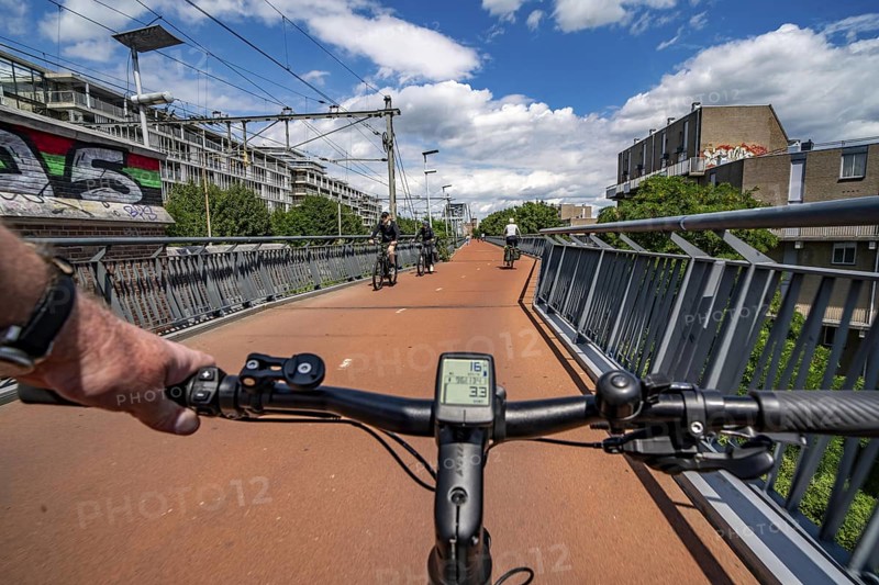 Ride over the Snelbinder Brug bicycle and pedestrian bridge, over the river Waal near Nijmegen, was built on the existing railway bridge, fast cycle path connection from the city centre of Nijmegen and the new housing estates in the Waalsprong district, Netherlands