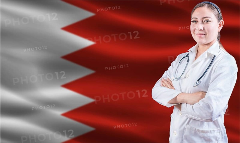 Female doctor on Bahrain flag. Doctor with crossed arms on Bahrain flag. Bahrain health and care concept