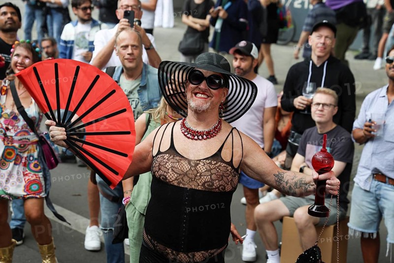 Man in net outfit with fan at the 47th Christopher Street Day under the motto Never again silent in Berlin on 26 July 2025
