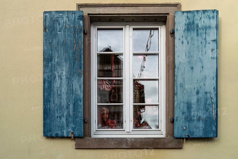 Window with blue shutters and reflections, Alsace, France