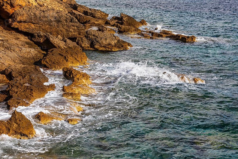 Rugged rocky coastline and foaming spray, on Stecci beach, near Capoliveri, Elba Island, Tuscan Archipelago National Park, Tuscany, Italy