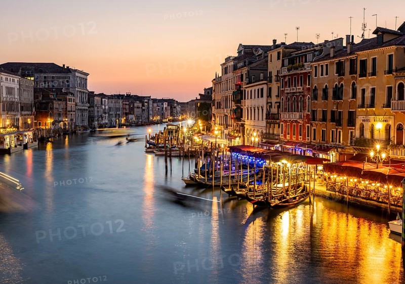 View of the Grand Canal at the blue hour, picturesque evening mood with illuminated palazzos on the canal, long exposure, view from the Rialto Bridge, Venice, Veneto, Italy