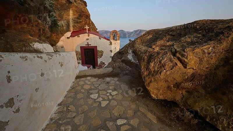 Legend, crab, shell fisherman, stone path to the chapel on the coast, surrounded by rocks, with calming sea view in the evening light, chapel, little church, Agia Kavouradena monastery, Xirokambos, Leros, Dodecanese, Greek Islands, Greece