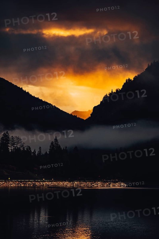 Surreal light atmosphere at sunrise at Plansee, Tyrol, in the Alps in Austria