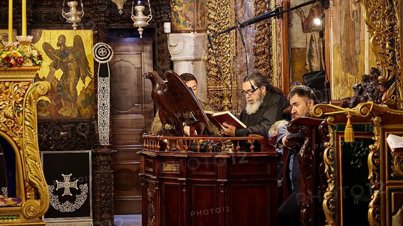 Men reading from religious books in a church decorated with icons, Holy Week, Bay of Panormitis, Panormitis Monastery, Symi, Dodecanese, Greek Islands, Greece