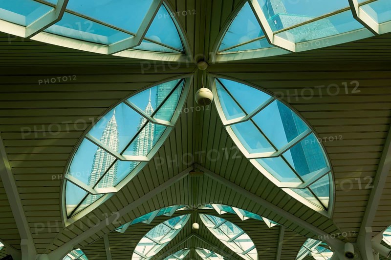 Petronas twin towers viewed through glass roofs of As Syakirin Mosque or KLCC Mosque, Kuala Lumpur, Malaysia, Asia