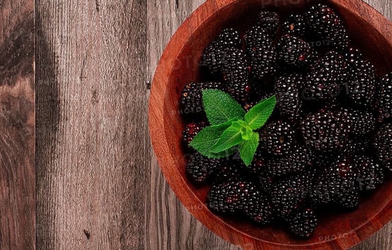 Blackberries, in a wooden bowl, top view, no people