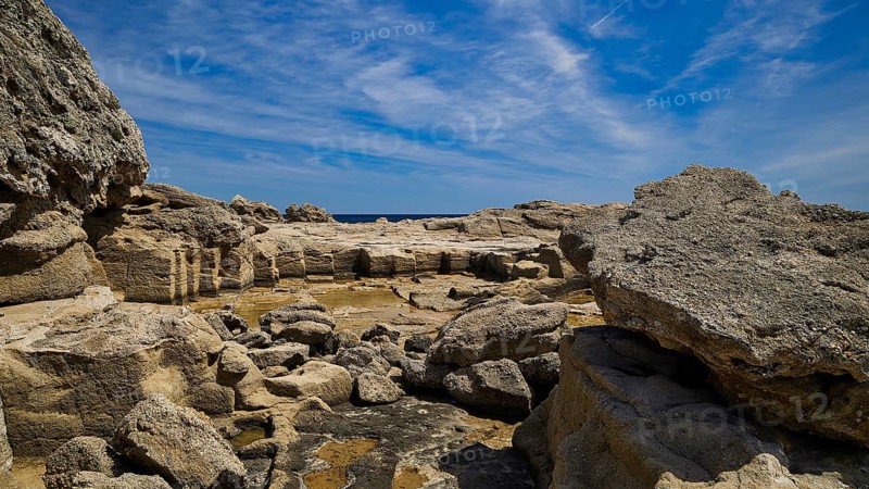 Expansive rocky landscape under a blue sky, Oasis Beach, east coast of Rhodes, Rhodes, Dodecanese, Greek islands, Greece