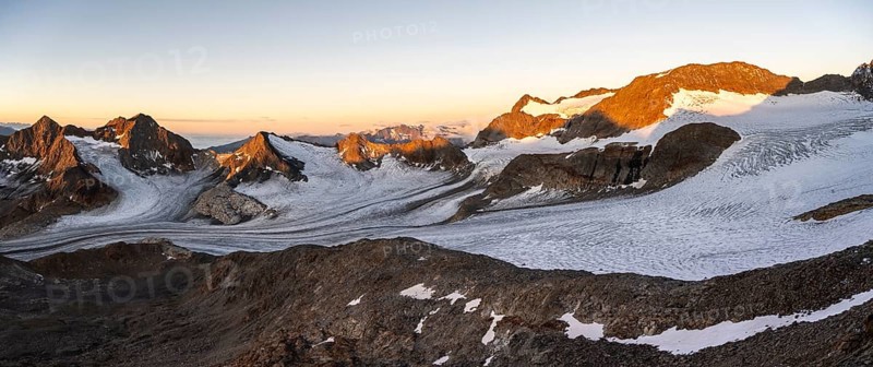 Picturesque high mountain landscape at sunrise with alpenglow, glacier and rocky mountain peaks in the morning light, view at Becher of mountain peaks Königshofspitz and Sonklarspitze and Schwarzwandspitz with glacier Übeltalferner, Stubai Alps, South Tyrol, Italy