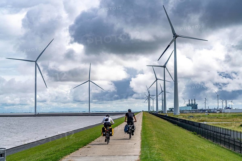 Strekdammen Wind Farm, wind farm at the seaport of Eemshaven in the Netherlands, left, built on offshore breakwaters, 2 GE Cypress 5, 5 MW turbines, with 158 metre blade diameter, together produce 11 MW of power, can supply 15, 500 households with electricity from wind, cumulus cloud over the North Sea, Netherlands