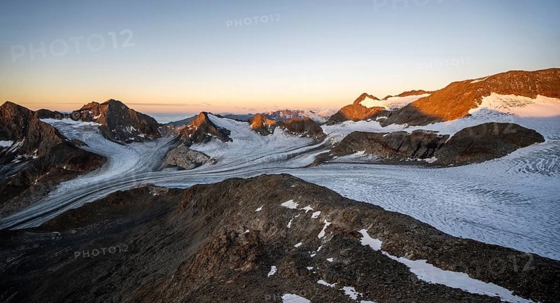 Picturesque high mountain landscape at sunrise with alpenglow, glacier and rocky mountain peaks in the morning light, mountain peaks Königshofspitz and Hofmannspitze with glacier of the Übeltalferner, Stubai Alps, South Tyrol, Italy