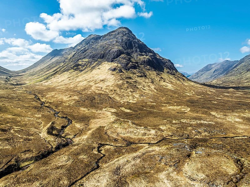 Buachaille Etive Beag and Three Sisters in Glencoe over Moors and Road A82 from a drone, Highlands, Scotland, United Kingdom