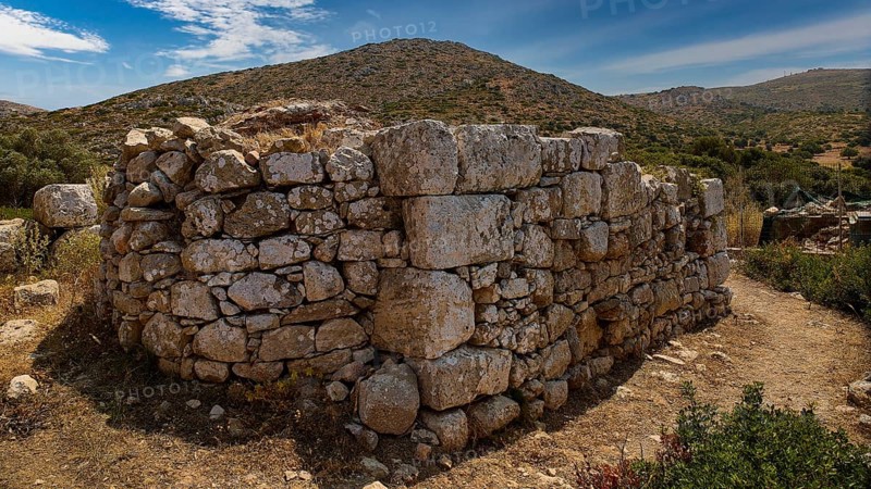 Sky exchanged, Large stone wall in an unspoilt mountain landscape with cloudy sky and surrounded by vegetation, Artemis Temple, Artemis, Diana, goddess of the hunt, altar. Church, tower, near the airport in the north of the island, Leros, Dodecanese, Greek Islands, Greece