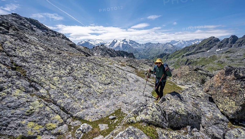 Mountaineer in rocky mountain landscape at the Col du Louvie, view of the summit of the Grand Combine, Valais Alps, Val de Bagnes, Valais, Switzerland