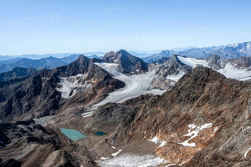 View of mountain basin with blue glacier lakes, behind summit Becher with Becherhaus, glacier Übeltalferner and summit Königshofspitz, descent from summit Wilder Freiger to Roter Grat, Stubai Alps, South Tyrol, Italy