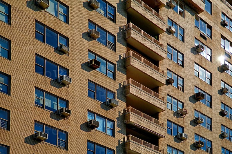 Brick façade of a high-rise building with air conditioning for the flats, New York City, USA