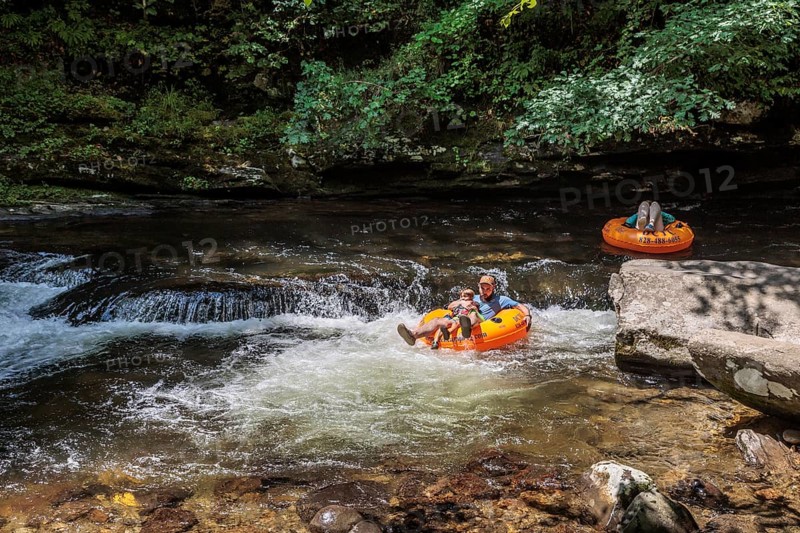 Visitors tubing down Deep Creek in the Smoky Mountains near Bryson City, North Carolina, USA