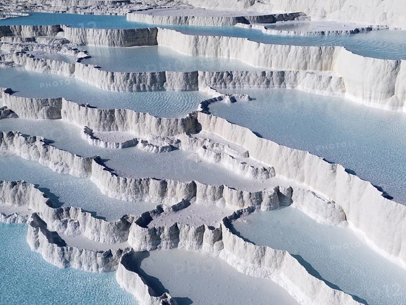 White limestone terraces with turquoise-coloured water under a clear sky, aerial view, sinter terraces, limestone sinter terraces, travertine terraces, Pamukkale, Denizli, UNESCO World Heritage Site, Anatolia, Turkey