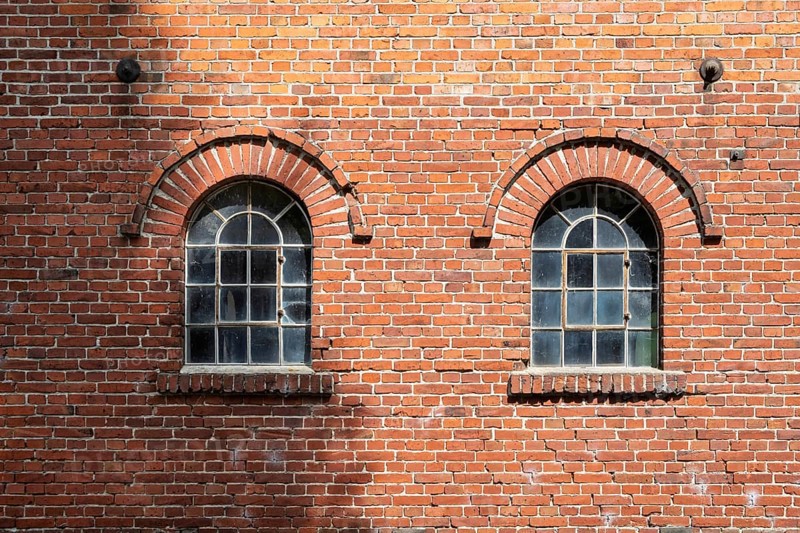 Old windows in a traditional brick wall with rustic charm and visible reflections, Stiftsmühle, Ochtrup-Langenhorst, Münsterland, North Rhine-Westphalia, Germany