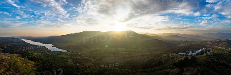 Panorama of Sunset over Mountains and Coniston Water from drone, Lake District National Park, Cumbria, England, United Kingdom