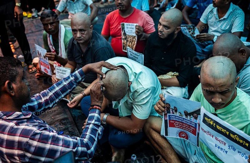 Drivers affiliated with Ola, Uber, and Rapido, under the banner of the Assam State Drivers' Union and the All Assam Cab Welfare Federation, shaved their heads in protest in Guwahati, India, on July 22, 2025. The demonstration held to highlight their demands for fair fare rates, regulation of aggregator commissions, and access to social security and welfare benefits
