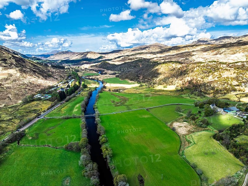 Farms and Mountains over River Dochart and Road A85 from a drone, Perthshire, Scotland, UK