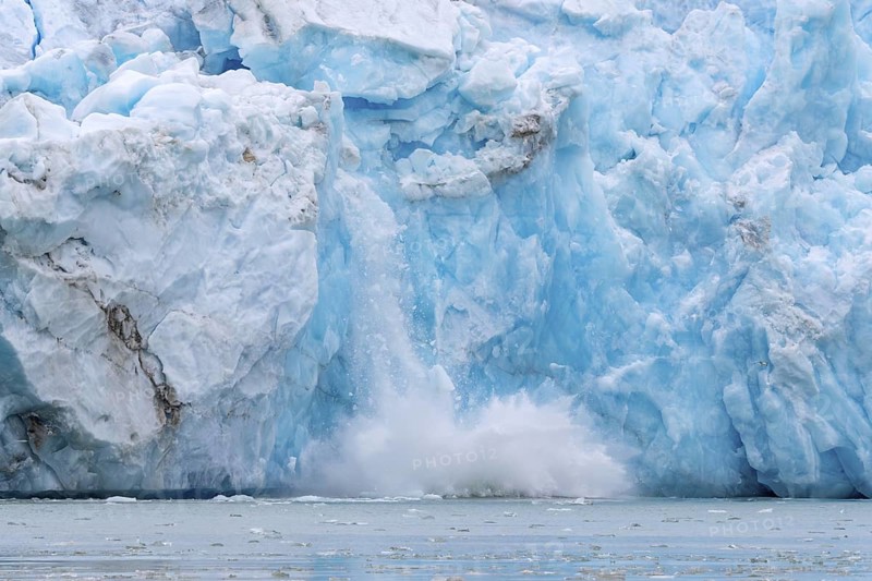 Collapsing ice wall of Fjortende Julibreen, 14th of July Glacier calving into Krossfjorden, Haakon VII Land, Spitsbergen, Svalbard, Norway