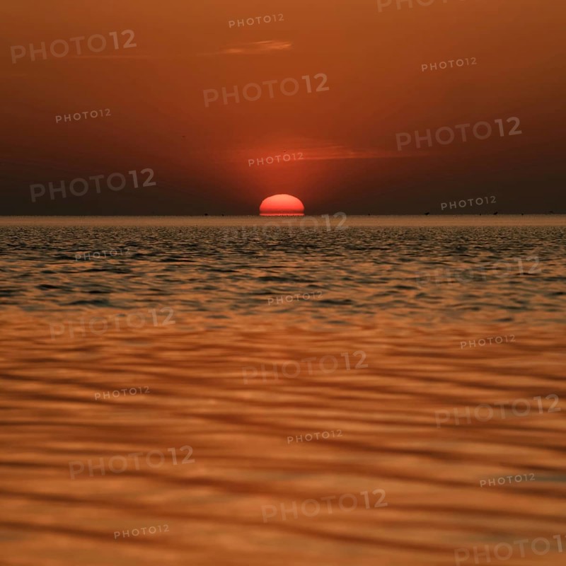 When the red sun sinks into the sea... Cuxhaven, North Sea, sunset in calm weather, glowing red fireball, sun sets fiery red over the sea, sinks into the sea, atmospheric picture, local nature, Lower Saxony Wadden Sea National Park, North Sea near Cuxhaven, Duhnen, Lower Saxony, Germany, Western Europe