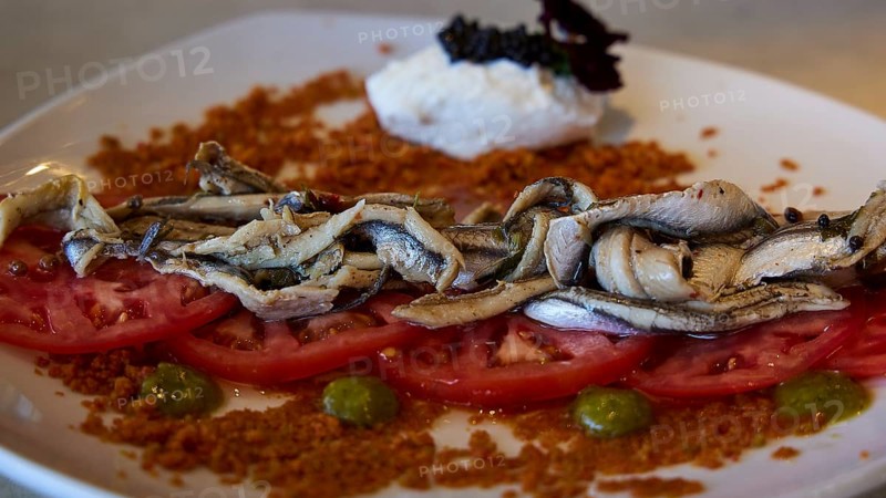 A plate of sardines on tomatoes, stylishly served with various ingredients, Stegna Beach, Stegna viewpoint, Stegna, east coast, Rhodes, Dodecanese, Greek Islands, Greece