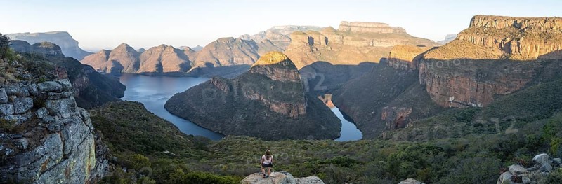 Hiker enjoying panorama, sunset at Blyde River Canyon with Three Rondawels peak, view of canyon with Blyde River and table mountains in the evening light, canyon landscape, Panorama Route, Mpumalanga, South Africa