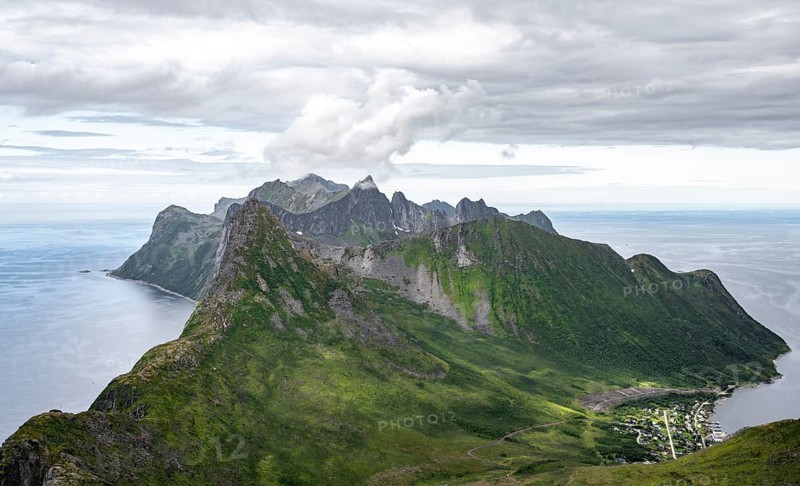 View of mountain peaks on the headland of Fjordgård with peak Segla, fjords Øyfjorden and Mefjorden, view from Barden mountain, Senja, Norway