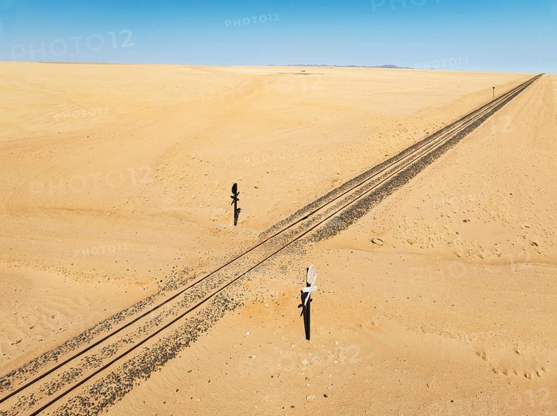 Rails and level crossing in the southern Namib Desert. Aerial view. Drone shot. Namibia