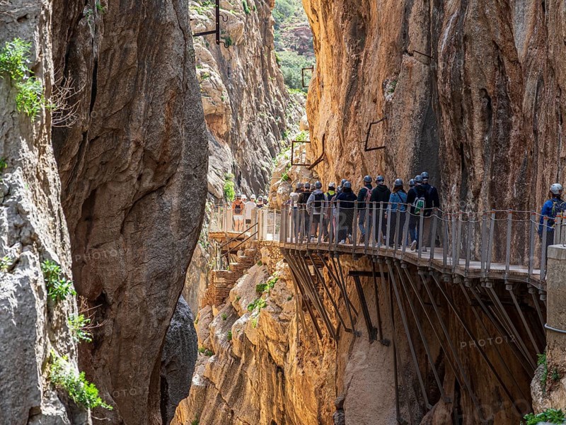 Tourists on the elevated path of the caminito del rey, along a deep gorge, Andalusia, Spain
