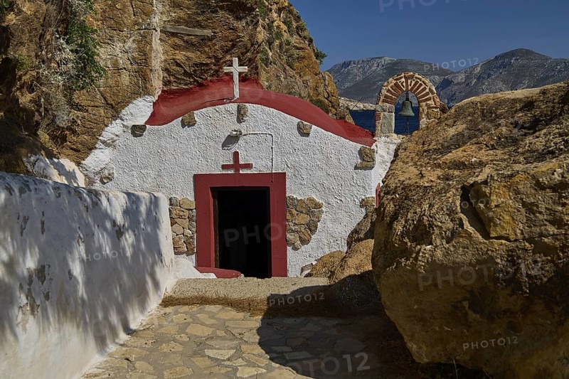 Legend, Crab, Mussel fisherman, Quiet chapel with red and white facade embedded in rocky landscape under blue sky, Chapel, Little church, Monastery Agia Kavouradena, Xirokambos, Leros, Dodecanese, Greek Islands, Greece