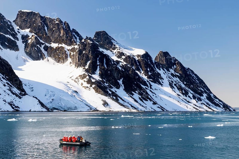 Zodiac in front of mountains with snow, sea, Smeerenburg, Spitsbergen, Svalbard