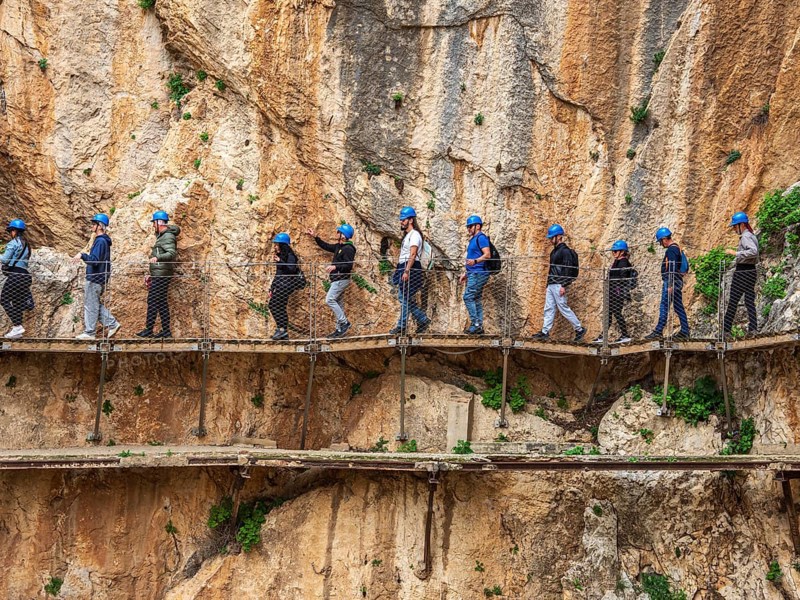 Tourists on the elevated path of the caminito del rey, along a deep gorge, Andalusia, Spain