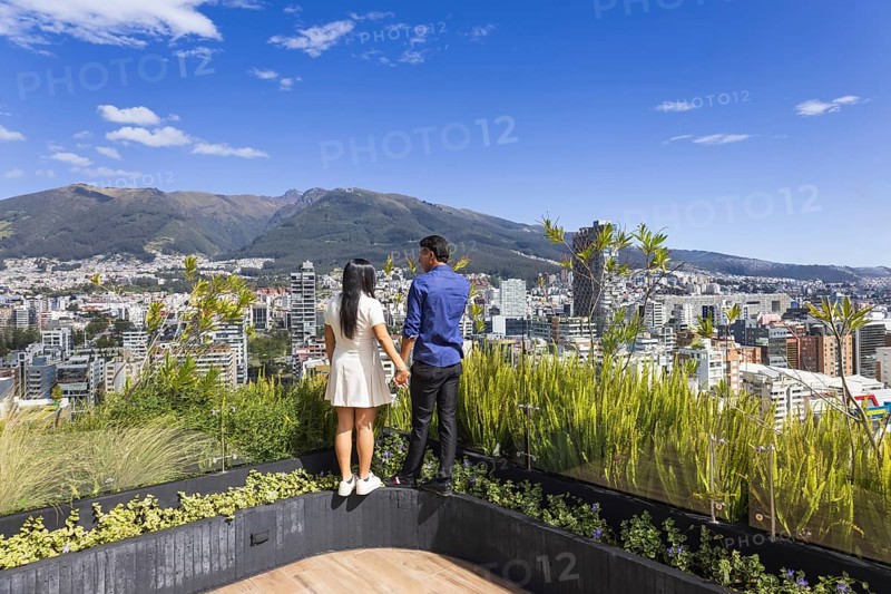 Quito, Ecuador, May 2 2025: Young tourist couple overview Carolina Park modern condominiums in Quito central business financial district