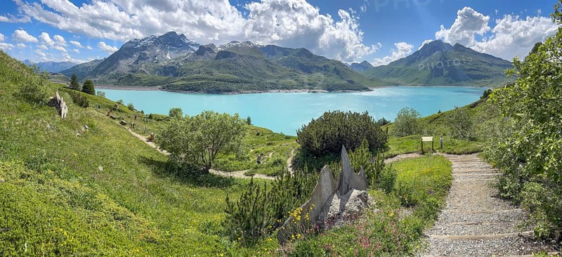 Panoramic view of Lac du Mont Cenis right path to alpine garden Jardin Alpin next to museum Musée du Mont Cenis on pass road to pass alpine pass mountain pass Col du Mont Cenis Colle del Moncenisio, Mont Cenis massif, Massif du Mont-Cenis, Graian Alps, Lanslebourg, Rhone-Alpes, France