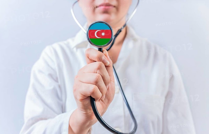 Female doctor holding stethoscope with Azerbaijan flag. National health system of Azerbaijan