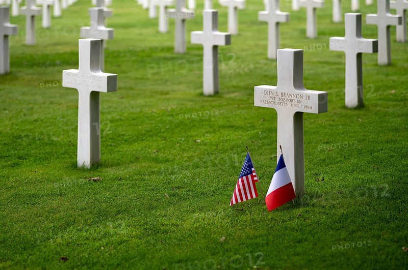US flag and French flag at the grave of John S Brannon jr, gravestones, war graves, military graves, military cemetery, American Normandy Cemetery, Normandy American Cemetery and Memorial, Omaha Beach, D-Day, Operation Overlord, Saint-Laurent-sur-Mer near Colleville-sur-Mer, Normandy, Calvados, France