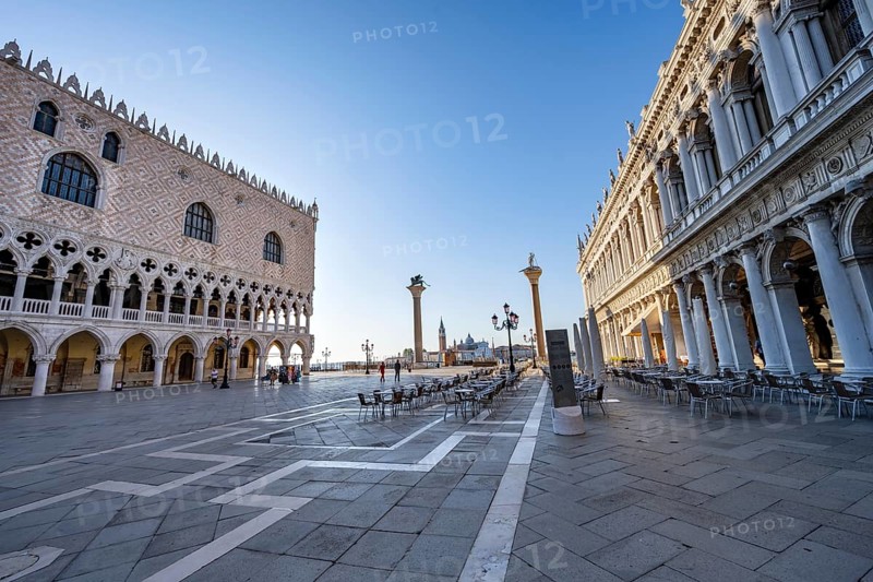 Chairs and tables of cafes at Piazetta San Marco, Doge's Palace and Colonna di San Marco and Colonna di San Todaro, in the morning light, St Mark's Square, Venice, Veneto, Italy
