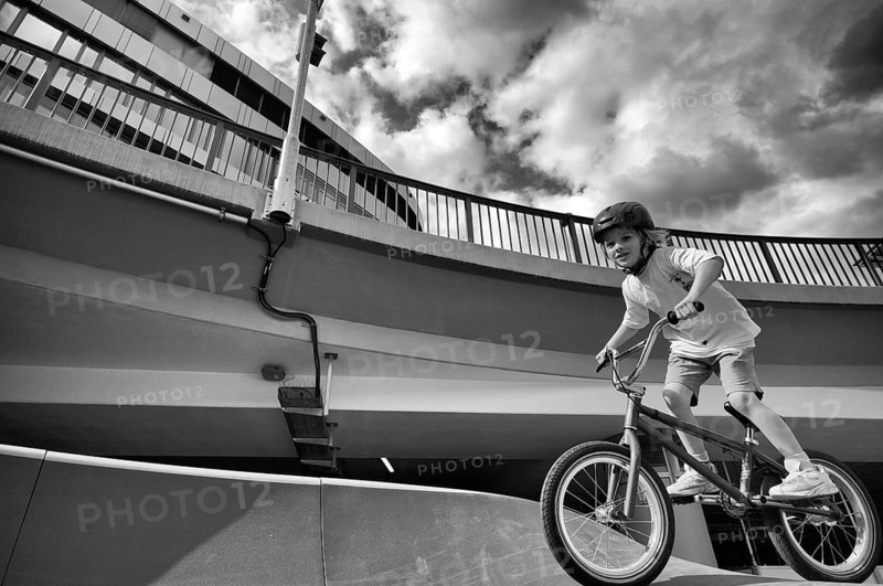 Boy, blonde, 6 years, riding bicycle, bike, crash helmet, subway, urban, concrete, black and white, Stuttgart, Baden-Württemberg, Germany