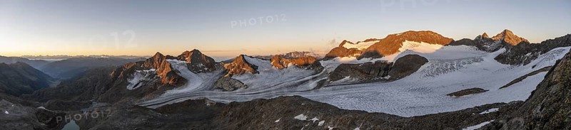 Picturesque high mountain landscape at sunrise with alpenglow, glacier and rocky mountain peaks in the morning light, view at Becher of mountain peaks Königshofspitz and Sonklarspitze and Schwarzwandspitz with glacier Übeltalferner, Stubai Alps, South Tyrol, Italy