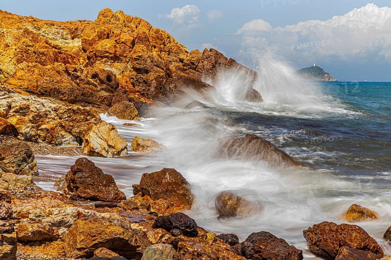 Rugged rocks and foaming spray on Topinetti beach, near Rio Marina, Elba Island, Tuscan Archipelago National Park, Tuscany, Italy