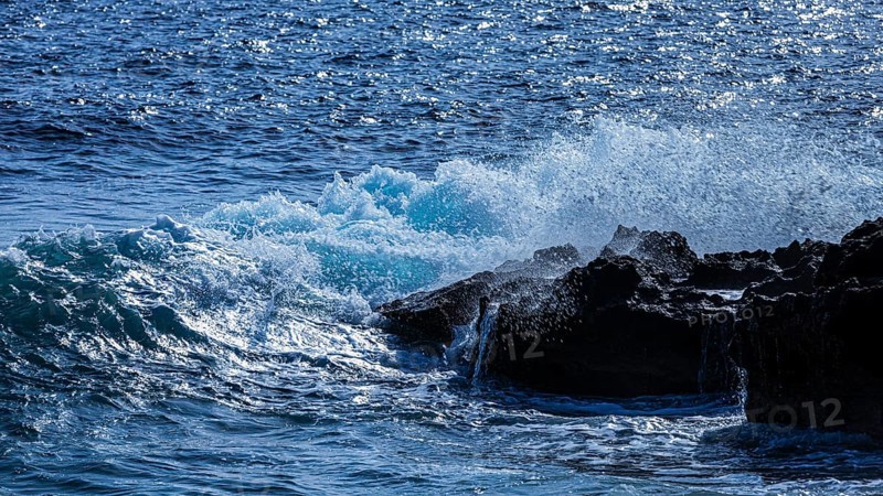 Rugged rocky coastline and foaming spray, on Stecci beach, near Capoliveri, Elba Island, Tuscan Archipelago National Park, Tuscany, Italy