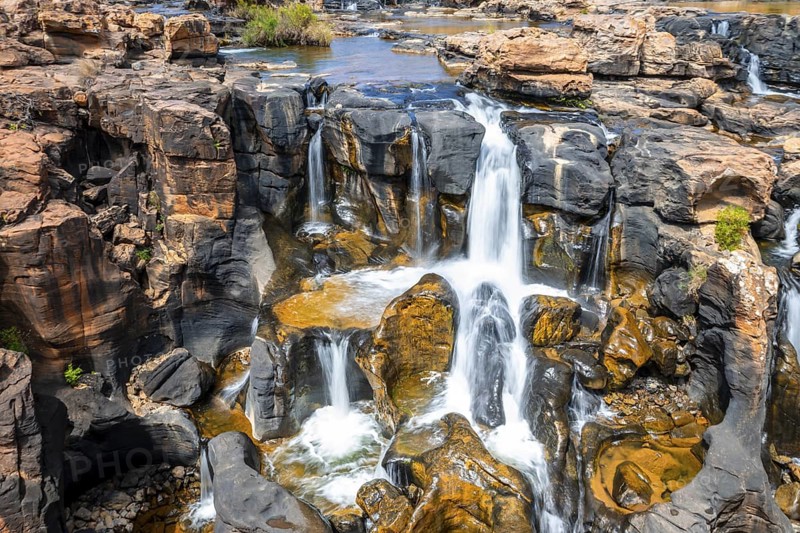 Waterfall on orange-coloured rock cliffs, long exposure, Blyde River, Bourke's Luck Potholes, Panorama Route, Mpumalanga, South Africa