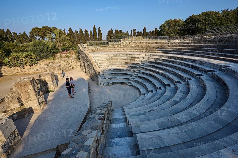 Ancient amphitheatre with stone steps and a few visitors, surrounded by nature, Ancient Theatre, Odeon, Kos Town, Kos, Dodecanese, Greek Islands, Greece