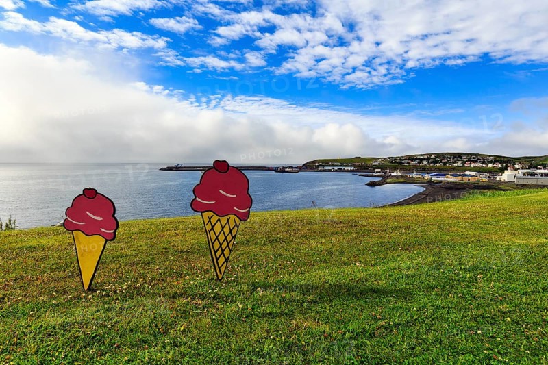 Two ice-cream cones in summer, signs in a meadow by the sea, fun decoration on Candy Day, Cumulus, town festival in Husavik, Húsavík, North Iceland, Iceland