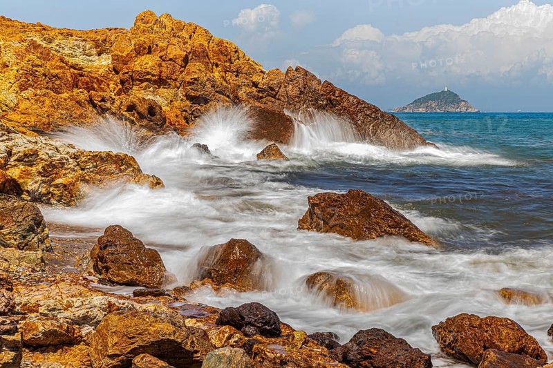 Rugged rocks and foaming spray on Topinetti beach, near Rio Marina, Elba Island, Tuscan Archipelago National Park, Tuscany, Italy